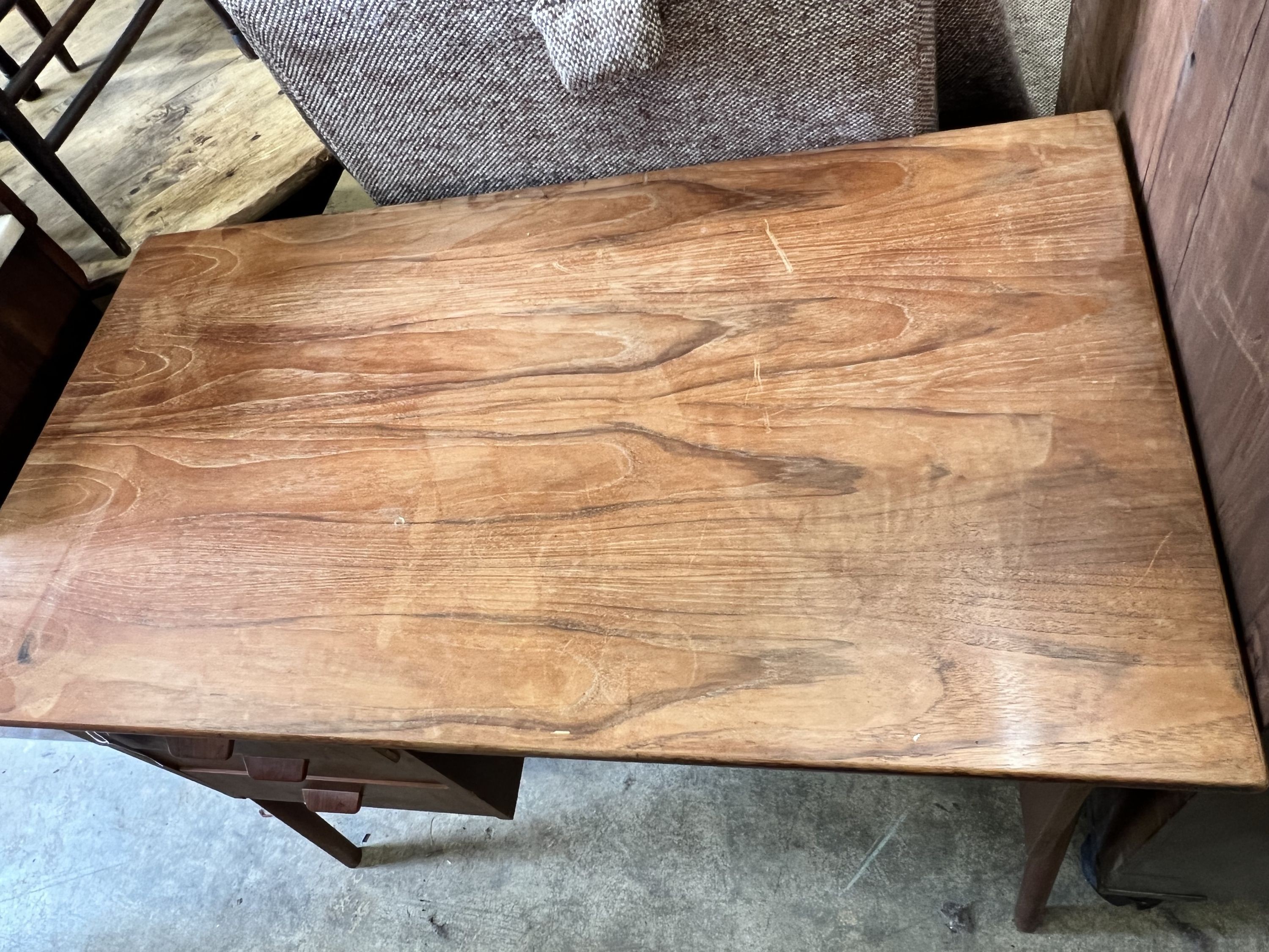 A mid century Danish style teak kneehole desk, width 105cm depth 59cm height 73cm